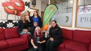 Pride Property Management Team on a couch indoors